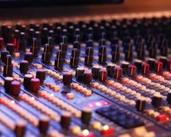 Close-up of professional front-of-house mixing board knobs, representing Stonehenge Sound's live audio engineering and monitor mixing services in Connecticut.